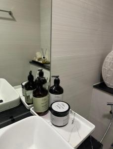 a bathroom with two bottles on a counter next to a sink at Autumn Falls, 2 Bedroom full service equipped appartement in Dubai