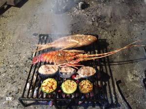 a fish and other foods on a grill at Casa-Poseidon in Hvar
