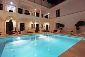 a large swimming pool in a large building at Hotel La Fonda in Benalmádena