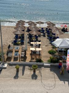 an overhead view of a beach with tables and umbrellas at Athanasiadis Studios in Nea Vrasna