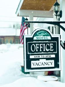 a sign for a motel office in the snow at Stowe Motel & Snowdrift in Stowe