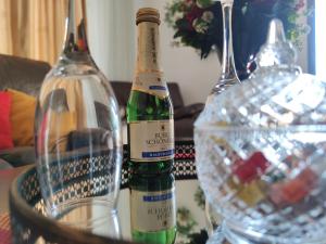 two bottles of wine are sitting on a table at Cozy Magic House - Unirii Square in Bucharest