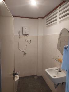 a bathroom with a sink and a toilet and a mirror at Khách Sạn Trung Mai in Ho Chi Minh City