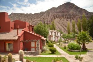 a row of houses in front of a mountain at El Refugio de Coquena in Purmamarca