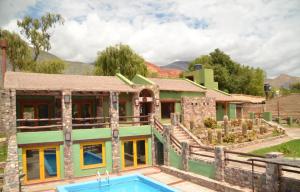 a house with a swimming pool in front of it at El Refugio de Coquena in Purmamarca