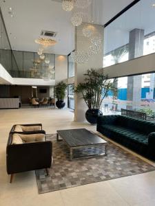 a living room with a couch and a coffee table at Hotel das Américas in Balneário Camboriú