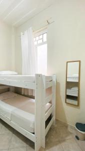 a bedroom with two bunk beds and a mirror at Hostel Canto Zen in Salvador