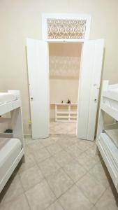 a room with white shelves and a tiled floor at Hostel Canto Zen in Salvador