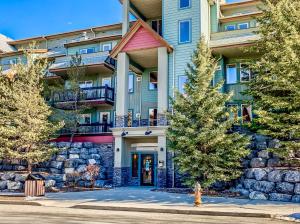 a apartment building with a fire hydrant in front of it at Canmore Mountain view loft apartment heated outdoor pool in Canmore