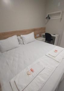 a large white bed with two pillows on it at Pousada Chapada do Araripe in Araripina