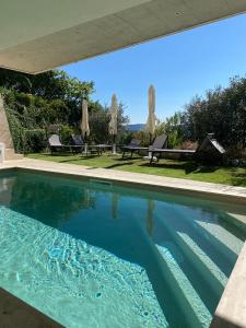 a swimming pool with blue water in a house at Villa Diamante del Garda & Spa in Toscolano Maderno