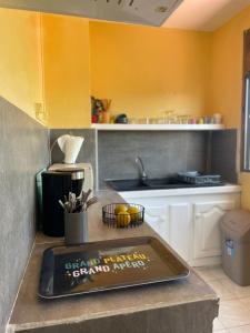 a kitchen with a counter with a sign on it at Appartement tout confort in Sainte-Anne