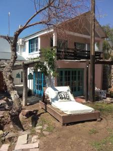 uma cama sentada no quintal em frente a uma casa em Casa con piscina a 5 minutos del centro em El Challao