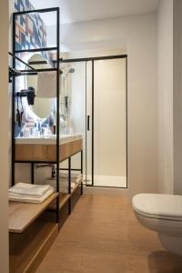 a bathroom with a toilet and a sink at Campanile Perpignan Aéroport in Rivesaltes