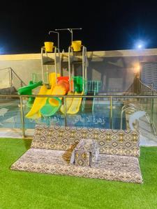 a water park with a slide and a playground at استراحة زهرة الاماكن 2 in Jeddah