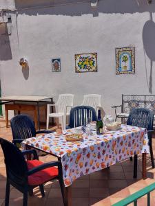 a table with chairs and a table cloth on it at JANET HOUSE in Amalfi