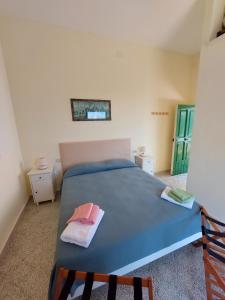 a bedroom with a blue bed with two towels on it at JANET HOUSE in Amalfi +27 photos