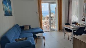 a living room with a blue couch and a table at The Father's House in Bol +31 photos