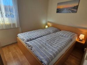 a bed in a bedroom with two lights on at Gorgeous home with swimming pool and Jacuzzi Sea view ! in Boltenhagen