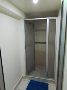 a shower with a glass door in a bathroom at Estancia la Ocho in Tijuana