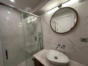 a bathroom with a sink and a shower with a mirror at Iris Han Hotel in Istanbul