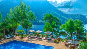 a pool at a resort with a view of the mountains at La Boheme Kabak Adults Only in Faralya