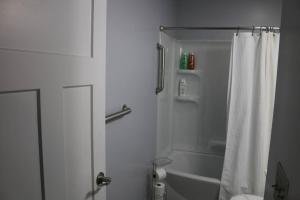 a bathroom with a white shower curtain and a tub at Rt. 682 Athens, 3 Queen bedrooms, 2 baths, Wi-Fi in Athens
