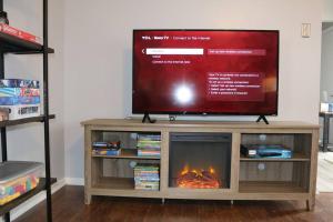 a television on a entertainment center with a fireplace at Rt. 682 Athens, 3 Queen bedrooms, 2 baths, Wi-Fi in Athens