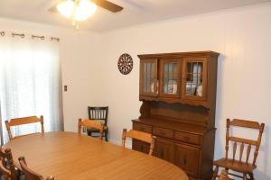 a dining room with a table and a wooden cabinet at Rt. 682 Athens, 3 Queen bedrooms, 2 baths, Wi-Fi in Athens