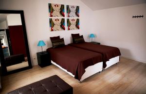 a bedroom with a large bed and a mirror at Triplex with Garage - Praça das Flores in Lisbon