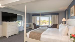 a bedroom with a large bed and a television at Breakwater Inn in Kennebunkport +38 photos