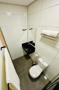 a small bathroom with a toilet and a sink at POUSADA ALTER PARA TODOS in Alter do Chao
