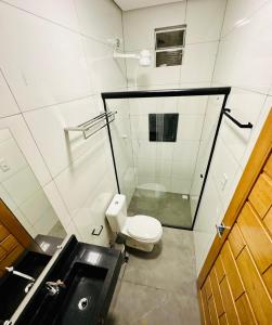 a small bathroom with a toilet and a sink at POUSADA ALTER PARA TODOS in Alter do Chao