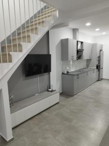 a kitchen with a staircase and a kitchen with a counter at Casa Elai in Sant Carles de la Ràpita