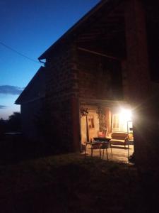 a house with a light on the side of it at night at C'est Chouette ! Les chambres ! in Saint-Jodard +48 photos