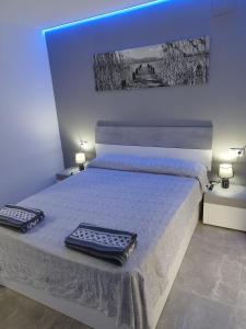a bedroom with a bed with two pillows on it at Casa Elai in Sant Carles de la Ràpita