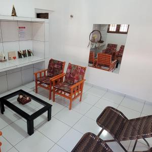 a living room with two chairs and a table at Casa em Tibau RN in Tibau