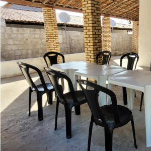 a white table and chairs on a patio at Casa em Tibau RN in Tibau