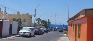 a street with cars parked on the side of the road at HOTEL 507 INN in Mejillones