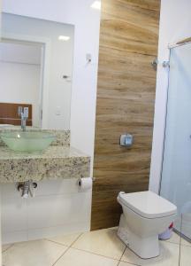 a bathroom with a sink and a toilet at Suite na Morada do Sol in Piratuba