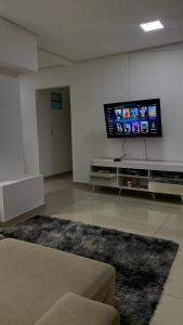 a living room with a flat screen tv on the wall at Estadia Fox in Lençóis