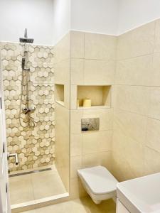 a bathroom with a toilet and a shower at Luca Apartman in Gyenesdiás