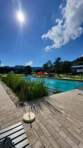 a bench sitting next to a swimming pool at FeWo Gretel in Schönwald