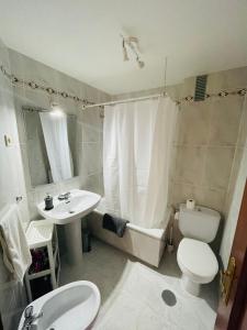 a bathroom with a sink and a toilet and a tub at CASA PURI in Candeleda +30 photos