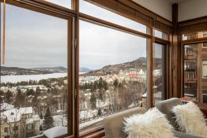 a room with a large window with a view of a city at Tremblant Prestige - Altitude 170-5 in Mont-Tremblant