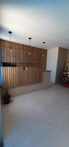 a hotel room with a sign on a wooden wall at Hotel Da Orla in Aracaju