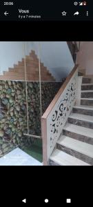 a picture of a staircase with a stone wall at Duplex mignant in Fez
