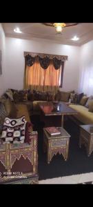 a living room with a couch and a table at Duplex mignant in Fez