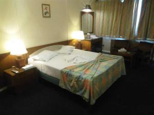 a hotel room with a bed and two lamps at Salvatore Room -Cairo Downtown in Cairo