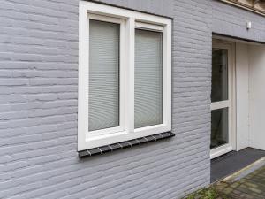 a window with blinds on the side of a house at Beautiful apartment on the first floor Abcoude in Abcoude
